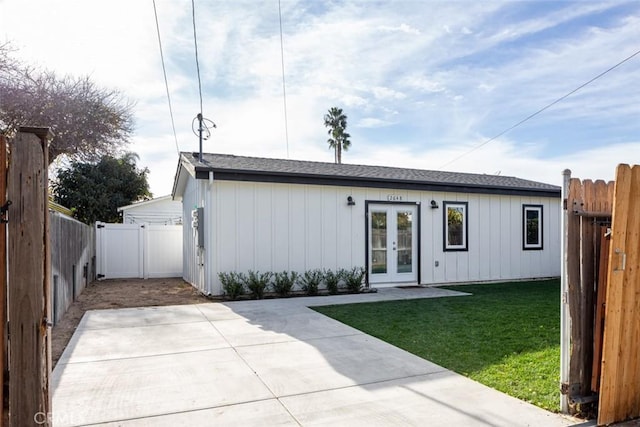 view of front of house with a front lawn, french doors, and a patio