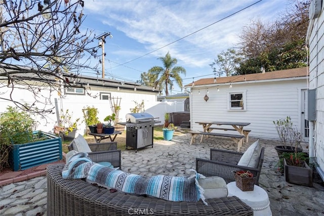 view of patio with an outdoor living space, a jacuzzi, and a grill