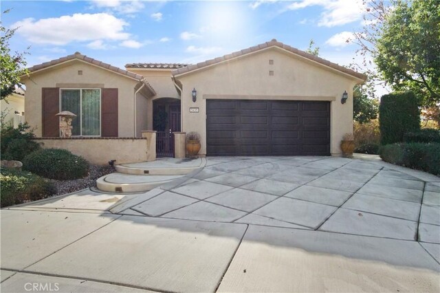 mediterranean / spanish-style house with a garage