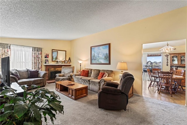 carpeted living room with a textured ceiling and lofted ceiling