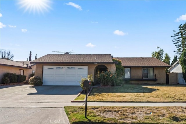 ranch-style house with a garage and a front lawn