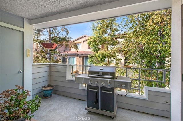 view of patio featuring a grill and a balcony