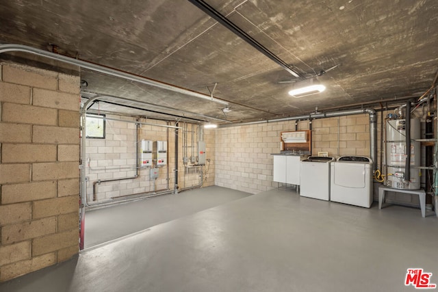 basement with water heater and independent washer and dryer