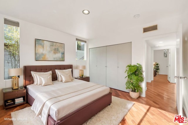 bedroom with wood-type flooring and a closet