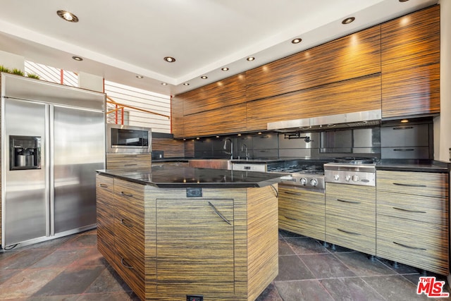 kitchen featuring a center island and built in appliances