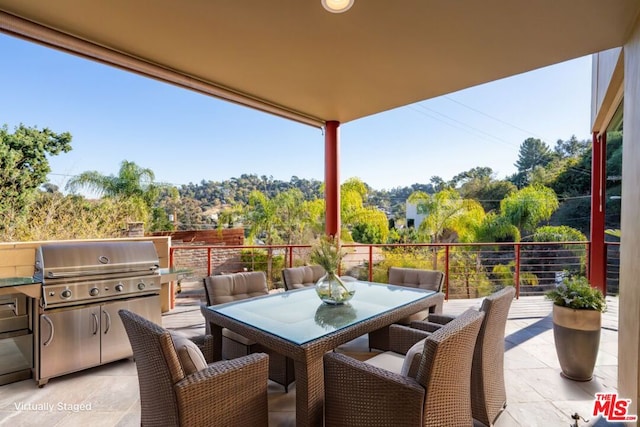 view of patio featuring a balcony and grilling area