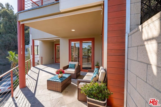 view of patio with an outdoor living space and a balcony