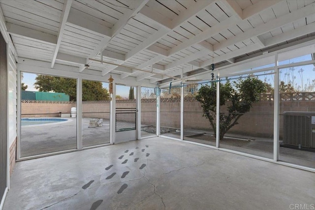 unfurnished sunroom with beam ceiling