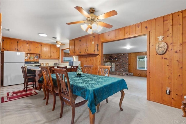 carpeted dining area with ceiling fan, billiards, and wooden walls