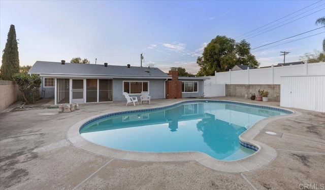 view of swimming pool with a patio