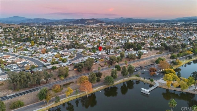 aerial view at dusk with a water and mountain view