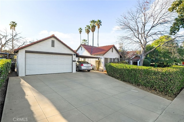 view of front of home with a garage and an outdoor structure