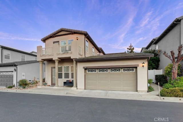 view of front of home with a balcony and a garage