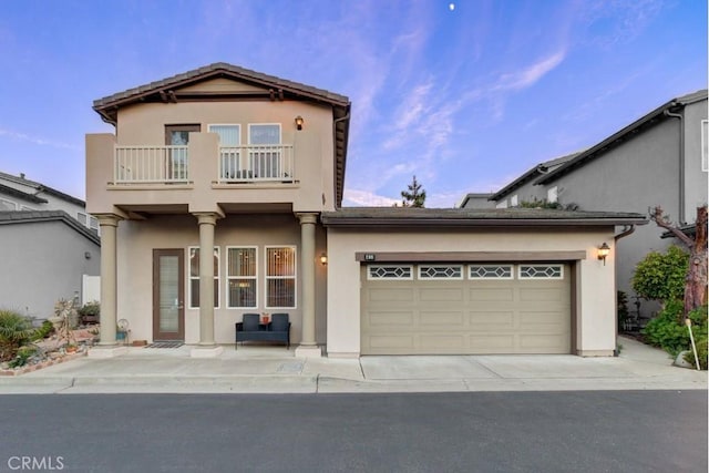 view of front of house featuring a balcony and a garage