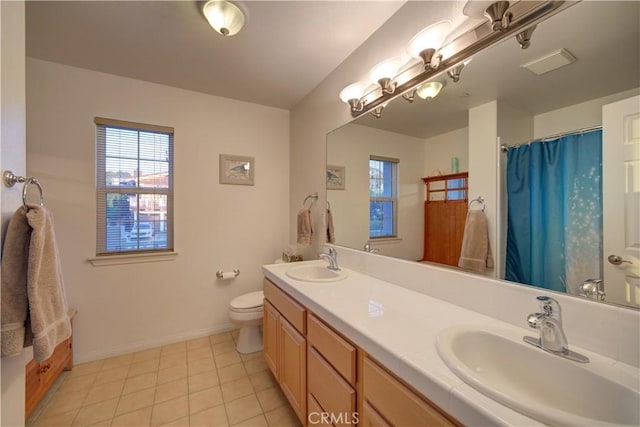 bathroom with vanity, tile patterned flooring, toilet, and curtained shower