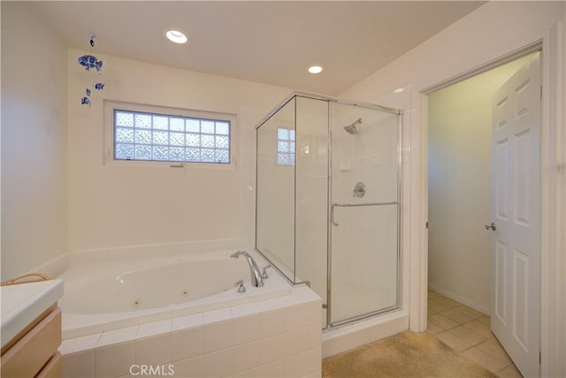 bathroom featuring tile patterned flooring, shower with separate bathtub, and vanity