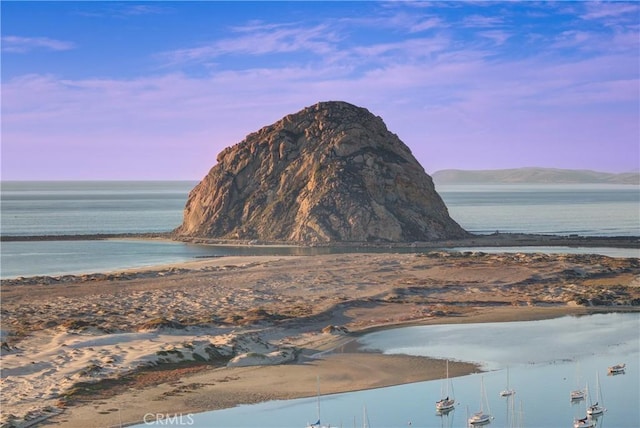 property view of mountains featuring a beach view and a water view