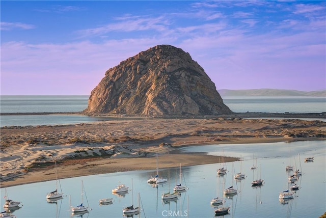 water view with a beach view and a mountain view