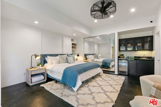 bedroom with a closet, indoor wet bar, and refrigerator