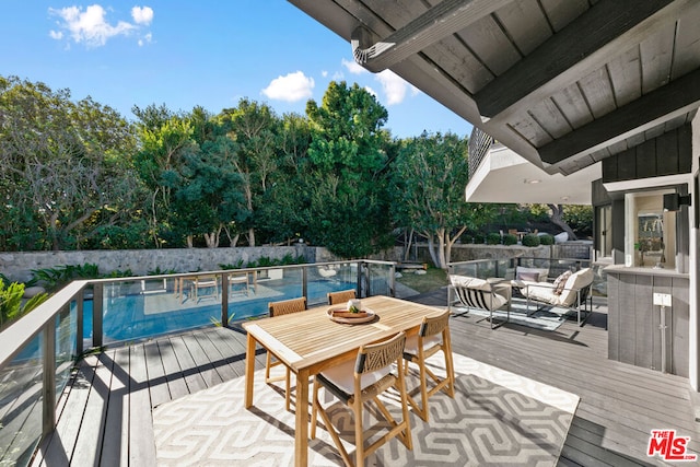 wooden deck featuring a fenced in pool