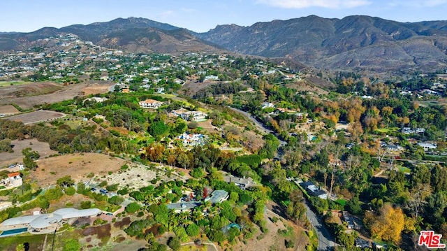 birds eye view of property with a mountain view