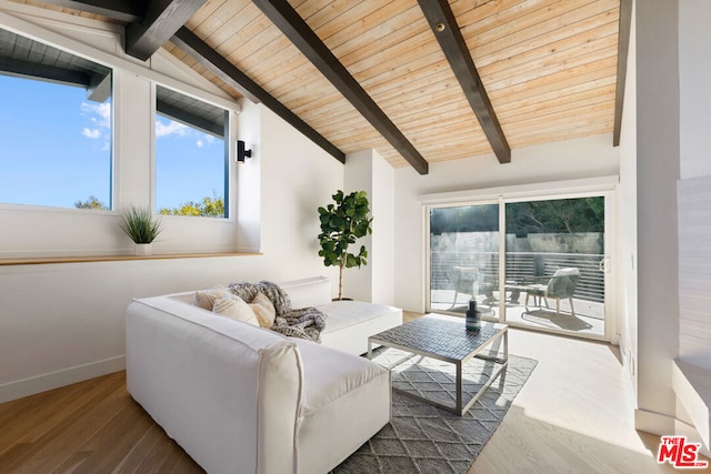 living room with wooden ceiling, a healthy amount of sunlight, hardwood / wood-style flooring, and lofted ceiling with beams