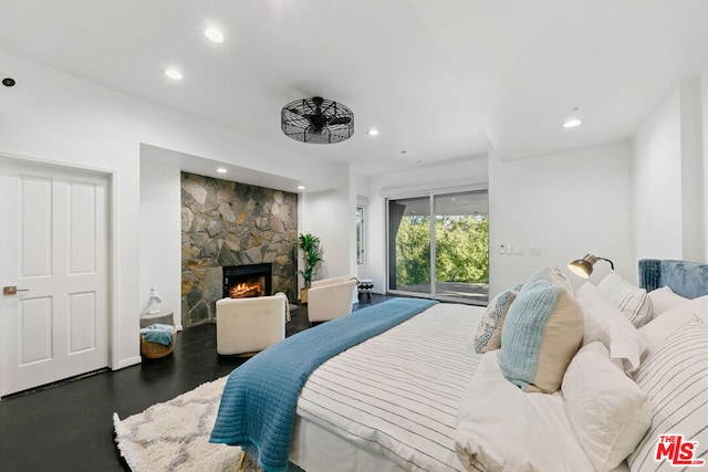 bedroom featuring access to exterior, a fireplace, and dark hardwood / wood-style floors