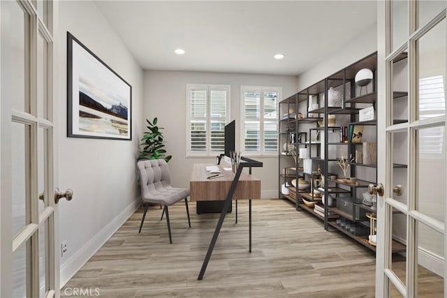 office space with light wood-type flooring and french doors