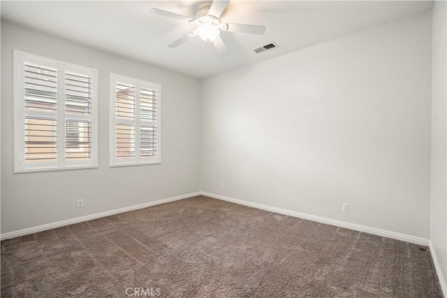 carpeted spare room featuring ceiling fan