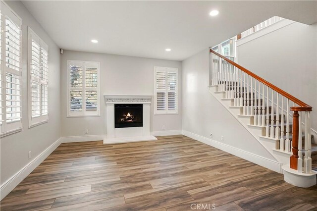 unfurnished living room with hardwood / wood-style flooring