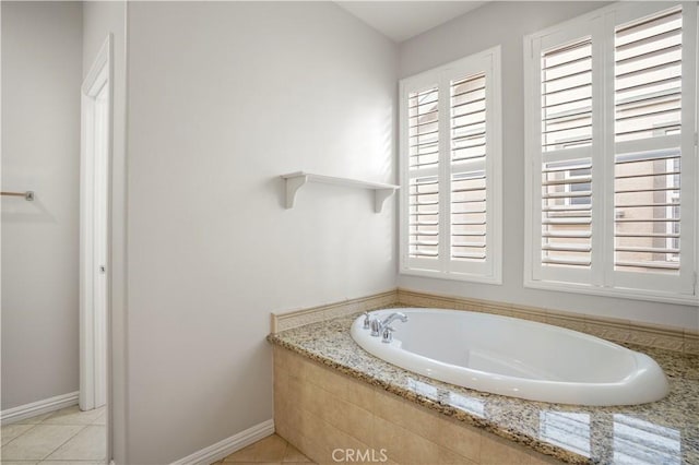 bathroom featuring tile patterned floors and tiled tub