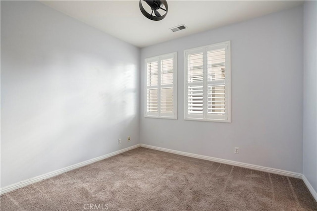 spare room featuring light colored carpet