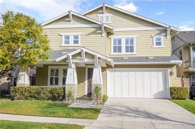 craftsman house with a garage and a front lawn