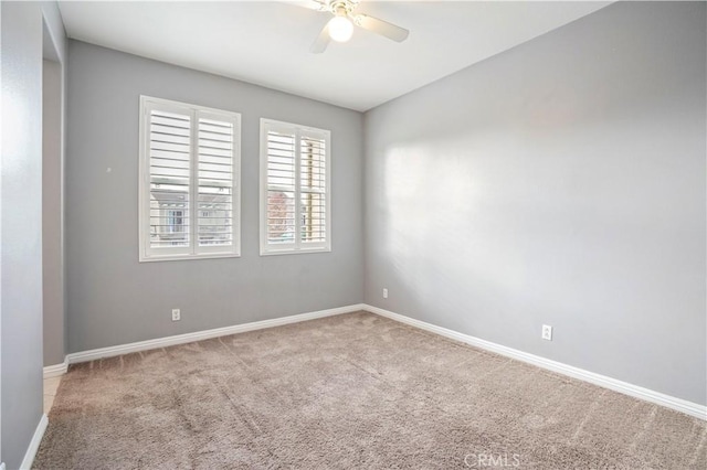 spare room with light carpet and ceiling fan