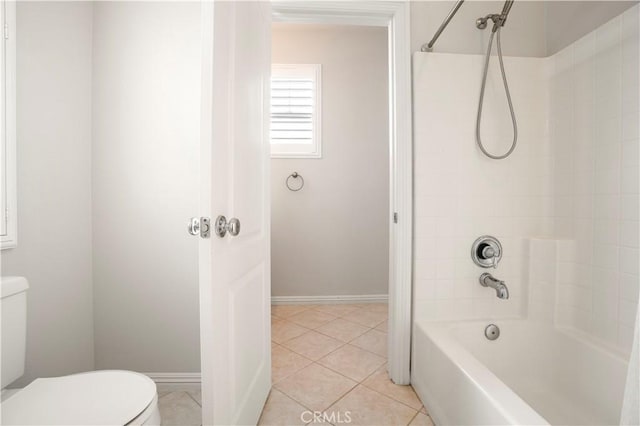 bathroom featuring toilet, tile patterned flooring, and washtub / shower combination