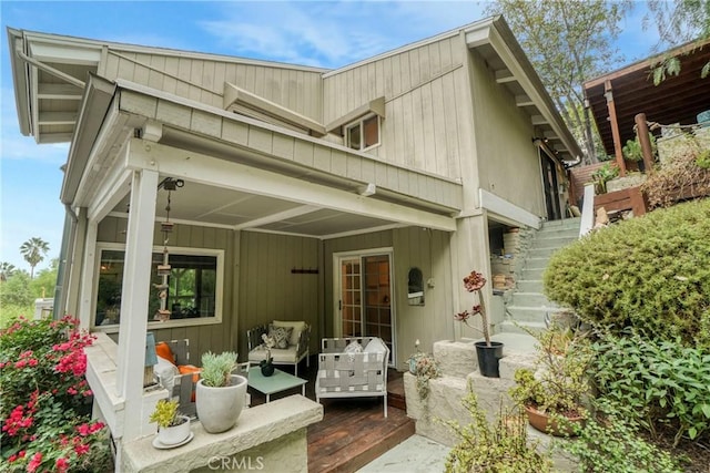 rear view of property with an outdoor living space