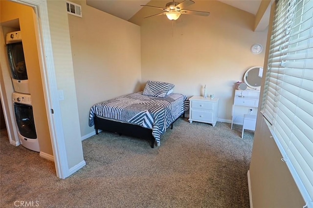 carpeted bedroom with lofted ceiling, ceiling fan, and stacked washing maching and dryer