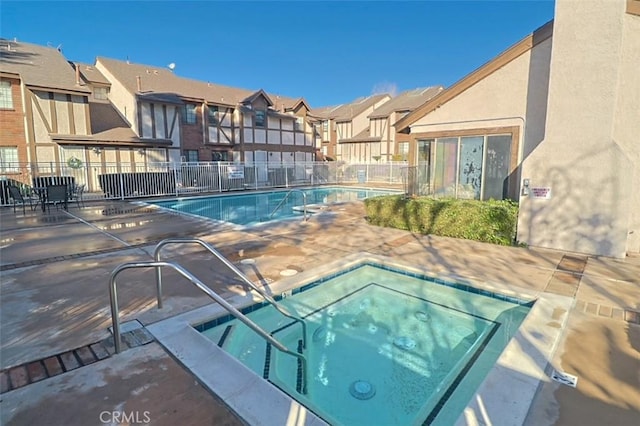 view of pool featuring a community hot tub and a patio