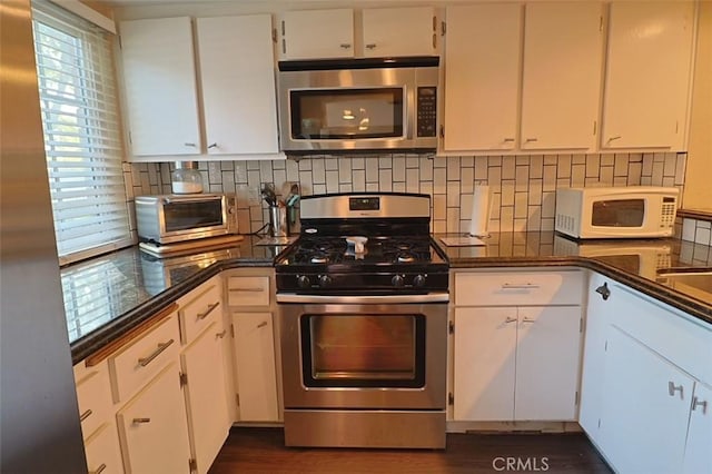 kitchen featuring white cabinetry, stainless steel appliances, and tasteful backsplash