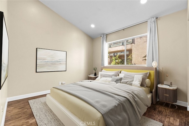 bedroom with dark hardwood / wood-style flooring and lofted ceiling