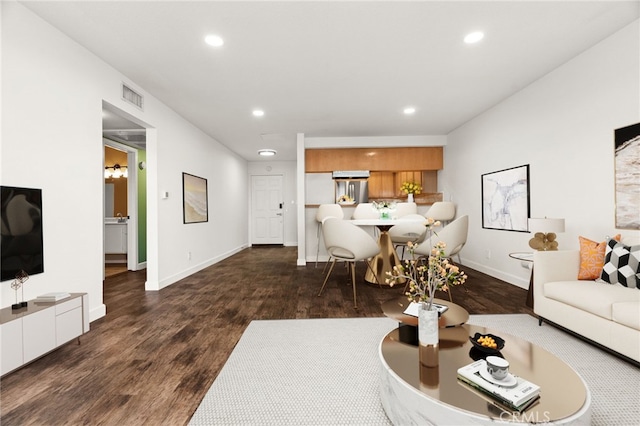 living room with dark hardwood / wood-style flooring