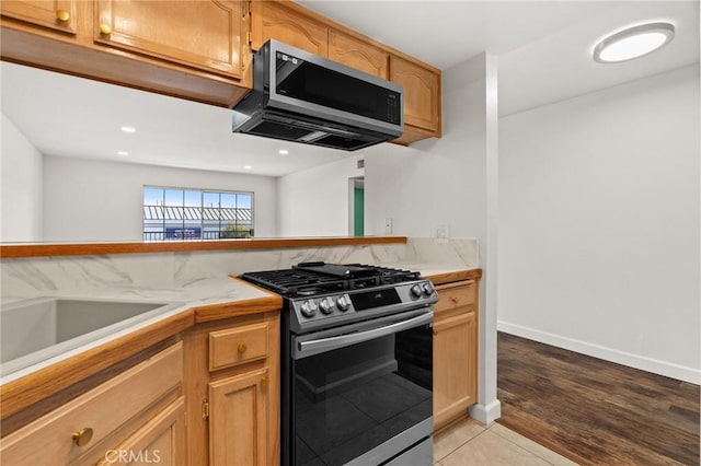 kitchen with light tile patterned floors, stainless steel appliances, and sink