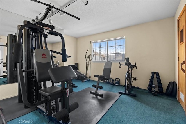 exercise room featuring a textured ceiling