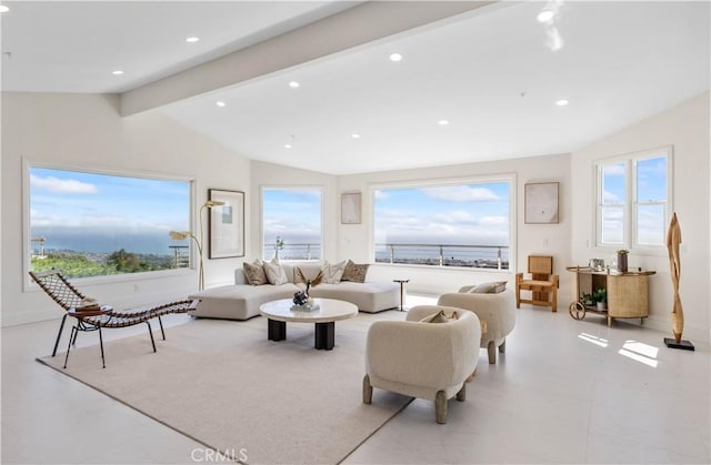 living room featuring lofted ceiling with beams, a water view, and a healthy amount of sunlight