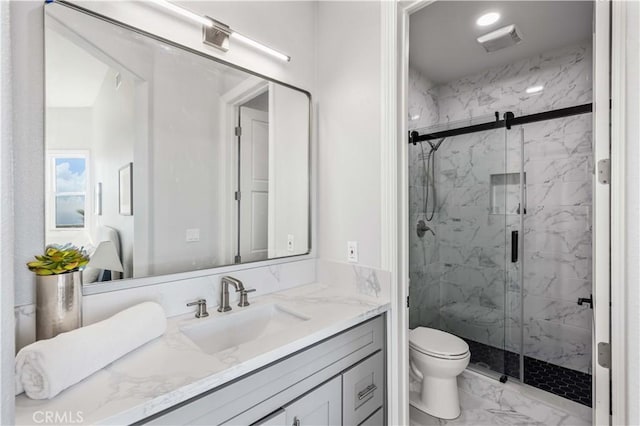 bathroom with a shower with shower door, toilet, and vanity