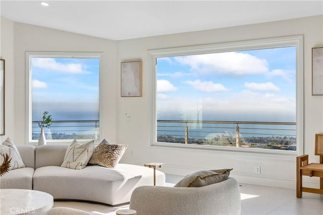 living room featuring lofted ceiling and a water view