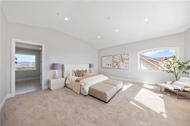 bedroom with vaulted ceiling and light carpet