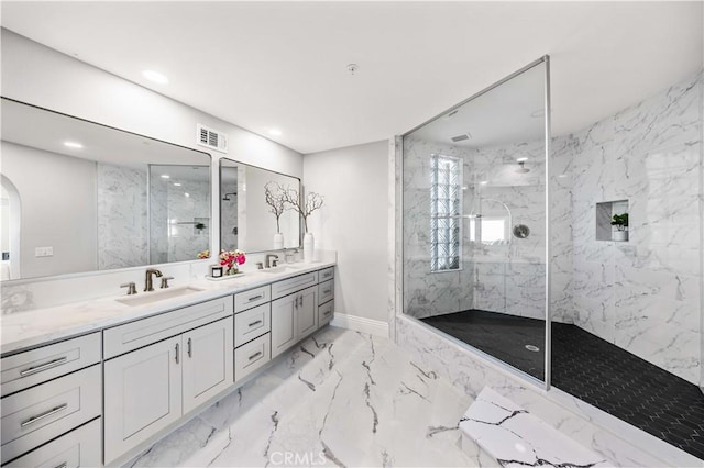 bathroom with vanity and a tile shower