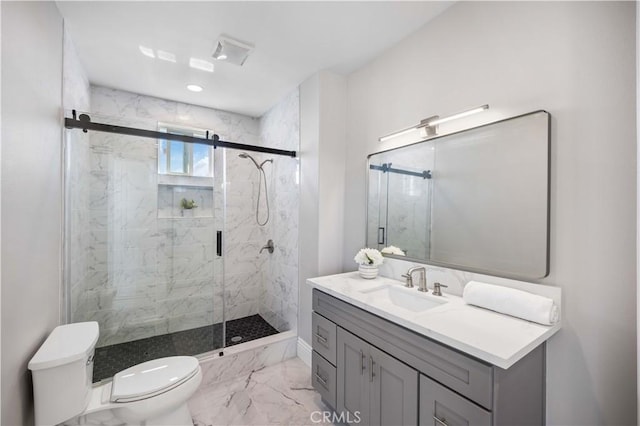 bathroom with an enclosed shower, vanity, and toilet