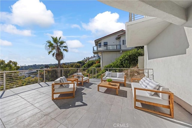 view of patio with a balcony and outdoor lounge area